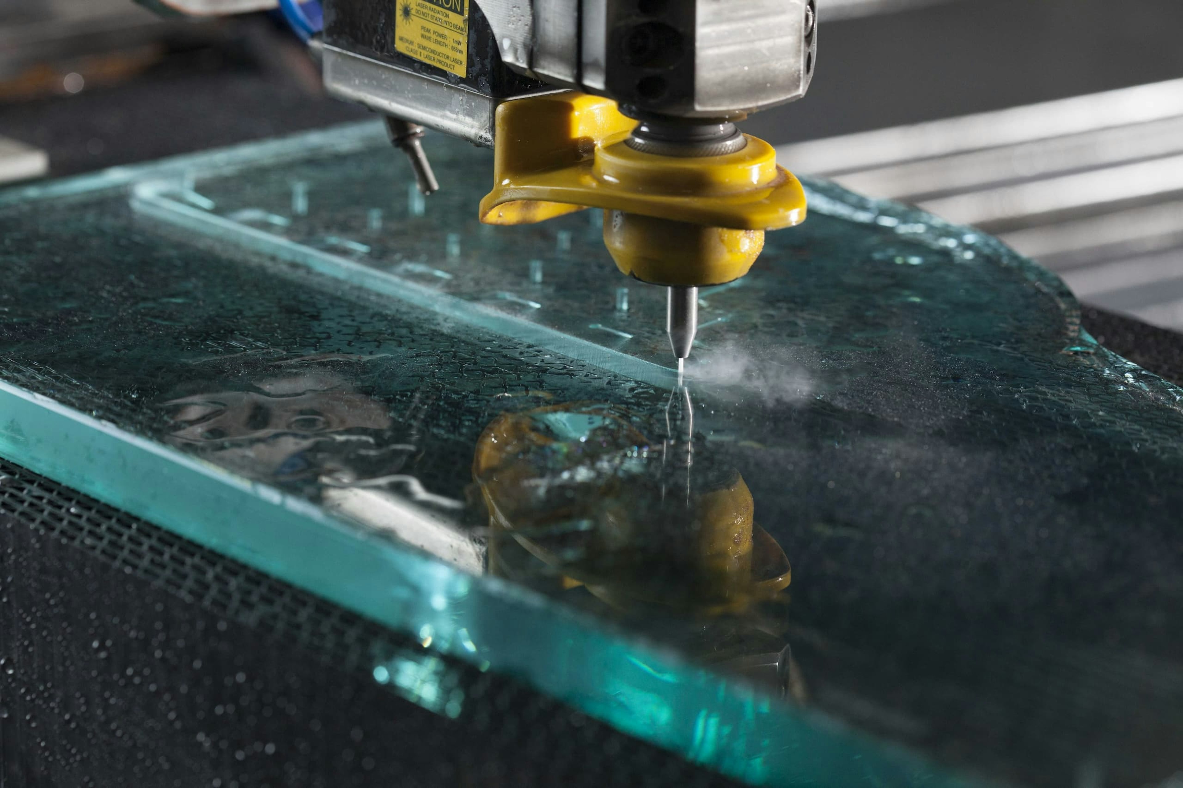 Close-up shot of a machine that is processing glass