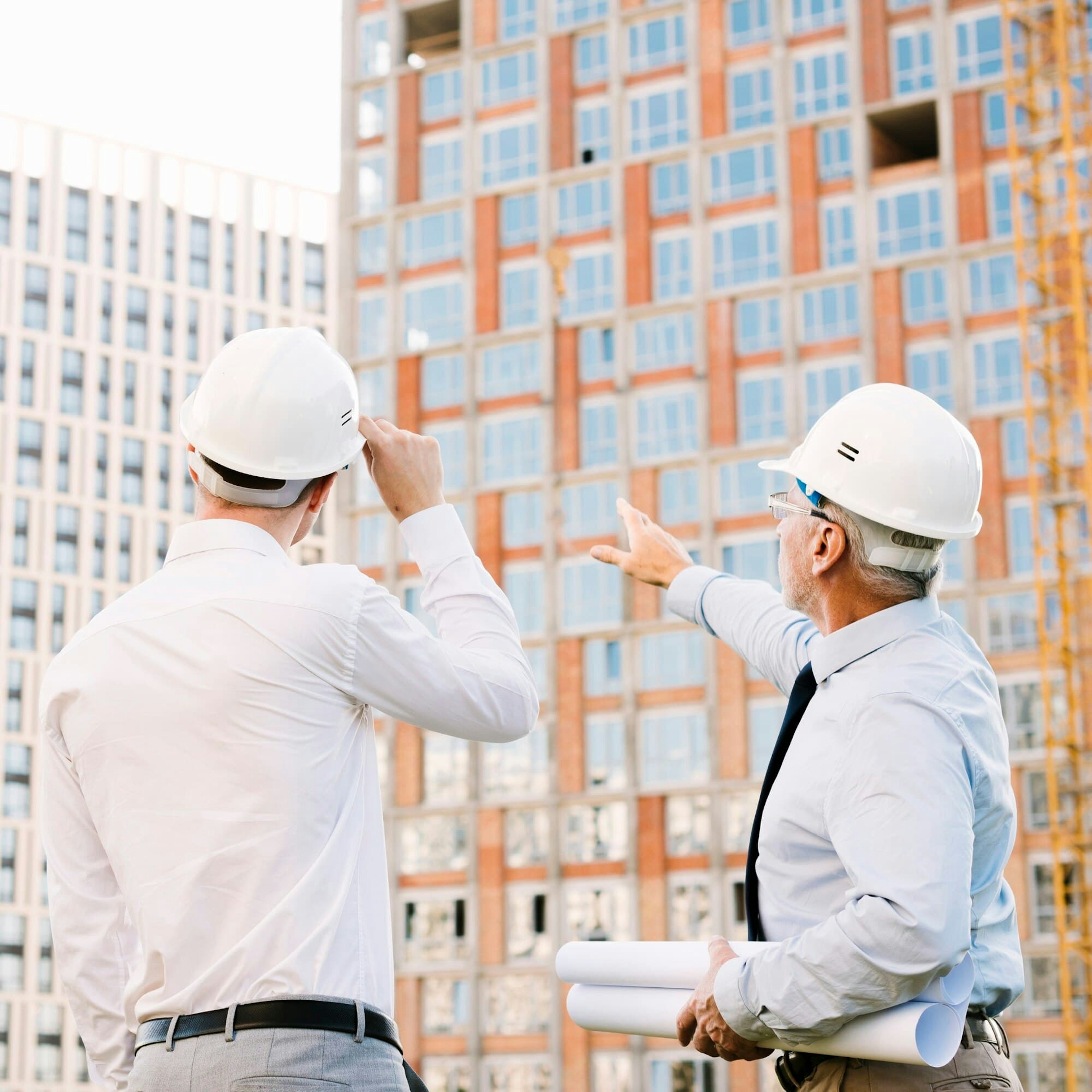 Two men are negotiating on a construction site