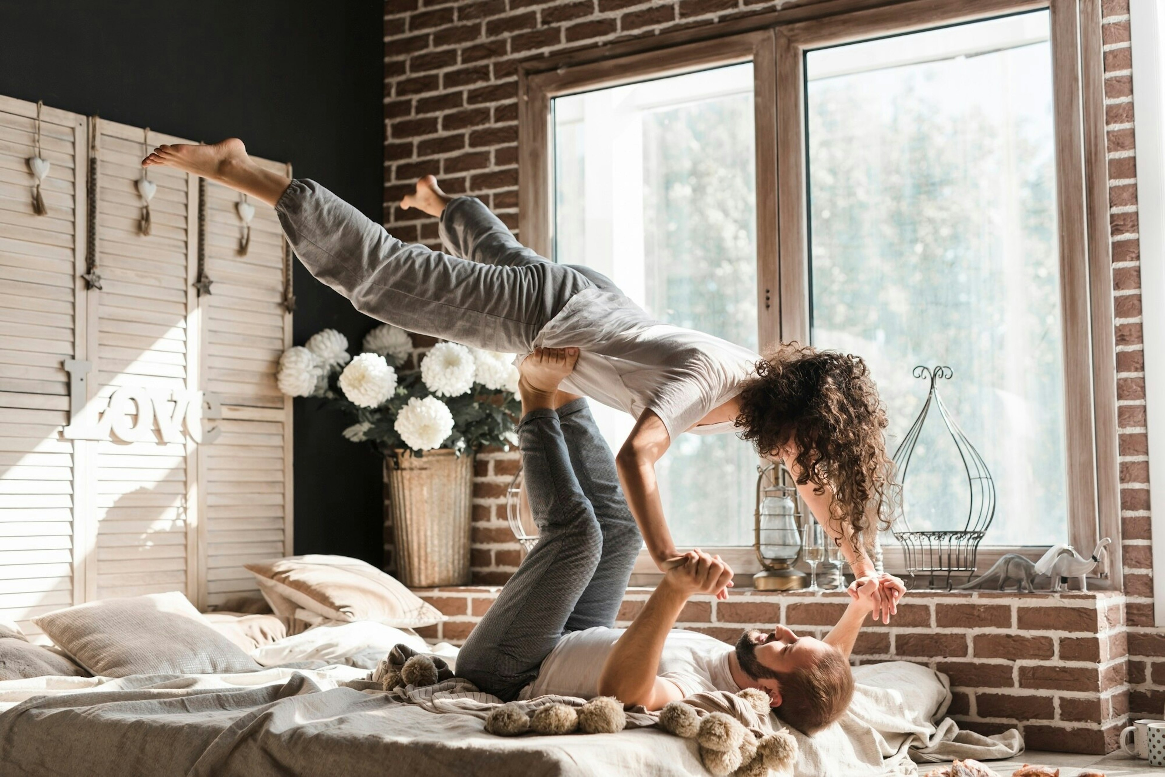 A couple is lying on the bed